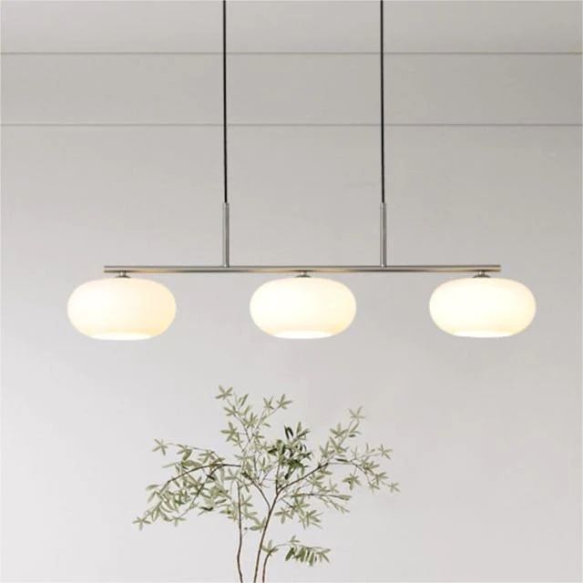 How far should a pendant light hang above a table?